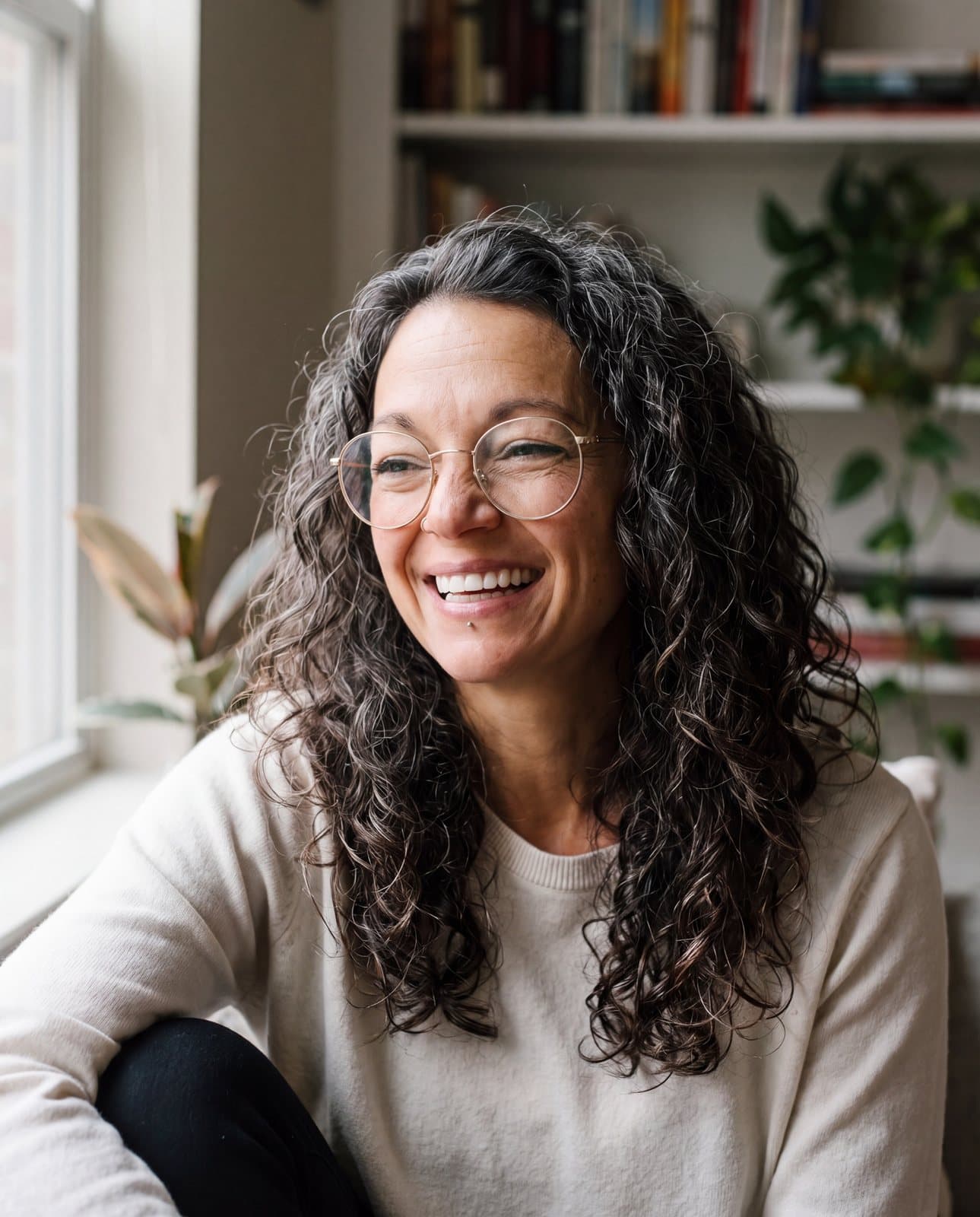 Leah Carr, founder of Love Covers, smiling by a window